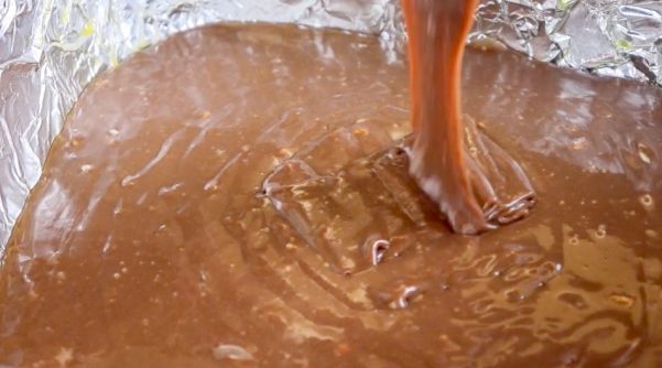 Picture of fudge being poured into a casserole dish.