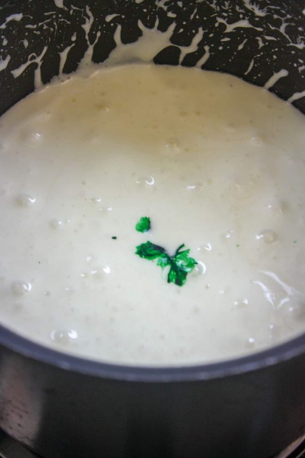 Picture of melted marshmallow in a saucepan with green food coloring