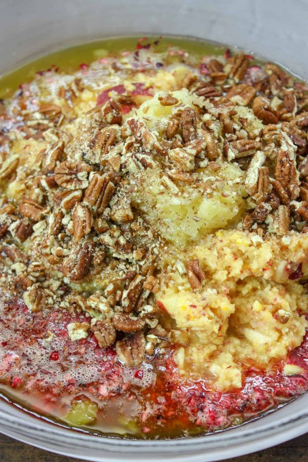 Picture of fruit, pecans, and cranberries in a bowl.