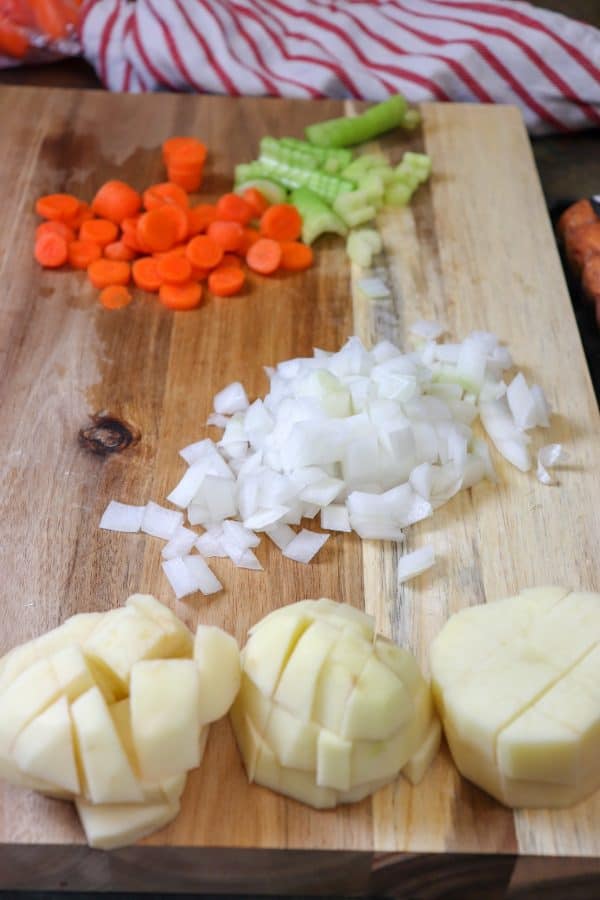 Picture of vegetables cut up on a wooden cutting board