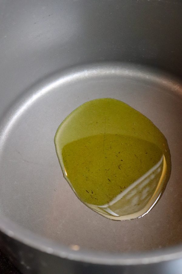 Picture of olive oil in a saucepan on medium heat.