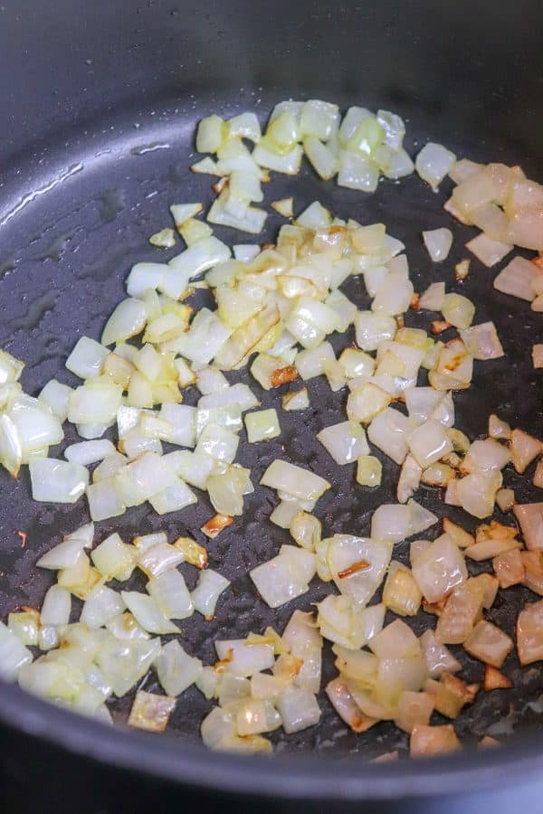 Picture of onions cooking in a saucepan. 