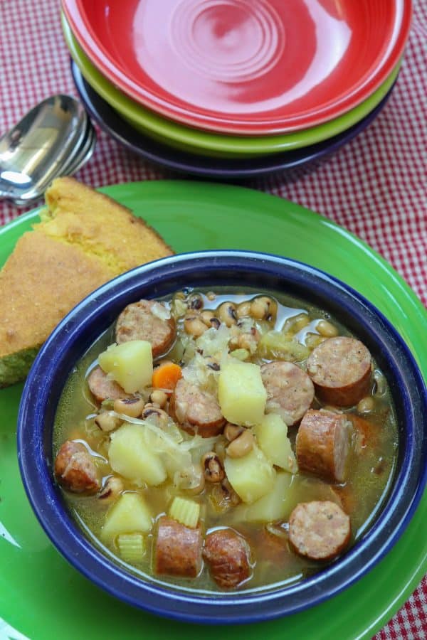 Picture of veggie soup in a bowl with smoked sausage.