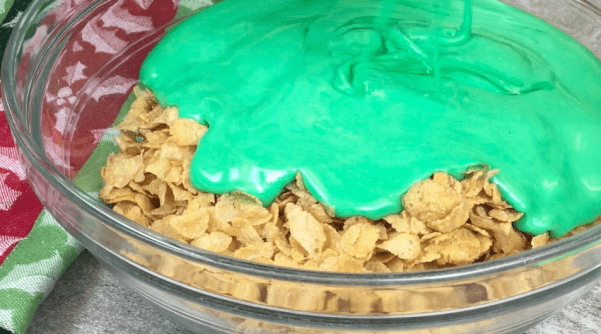 Picture of green marshmallow being poured over Corn Flakes