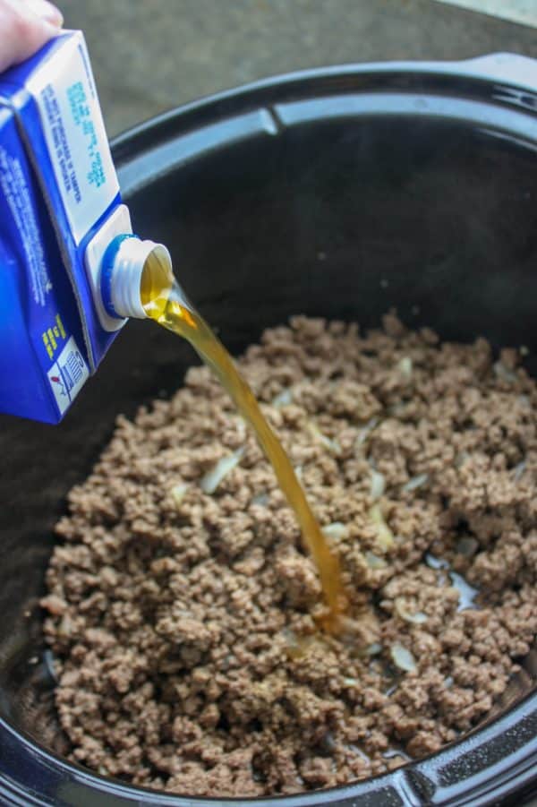 Picture of ground beef and beef broth in a Crock Pot