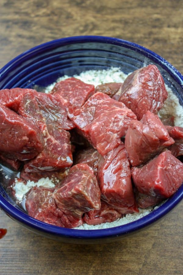 Picture of stew meat in a large bowl with flour