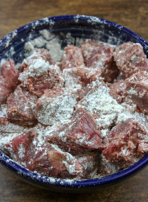 Picture of stew meat covered in flour in a bowl