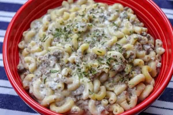 Picture of beef and noodles in a large red bowl