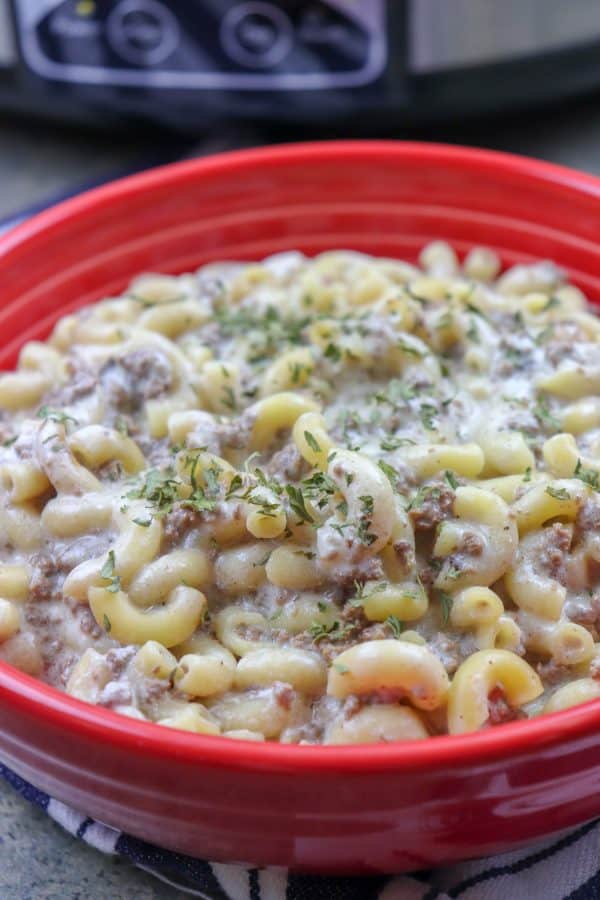 Picture of beef and noodles in a red bowl