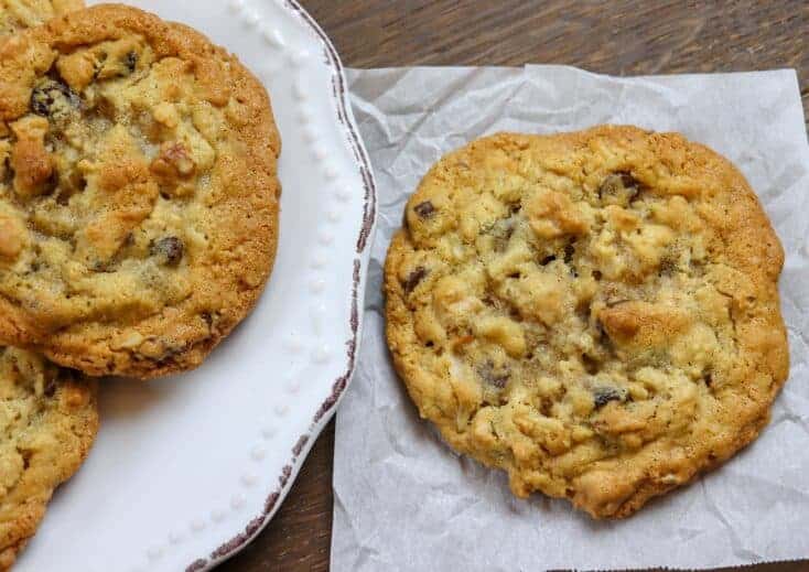 Cookies sitting on a plate and on parchment paper.