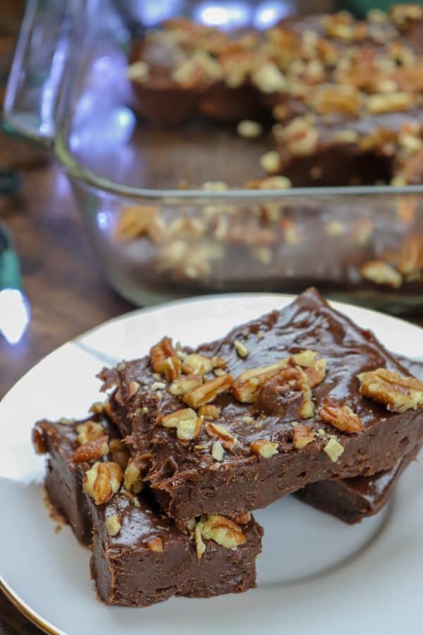 Picture of fudge with pecans on a white plate.