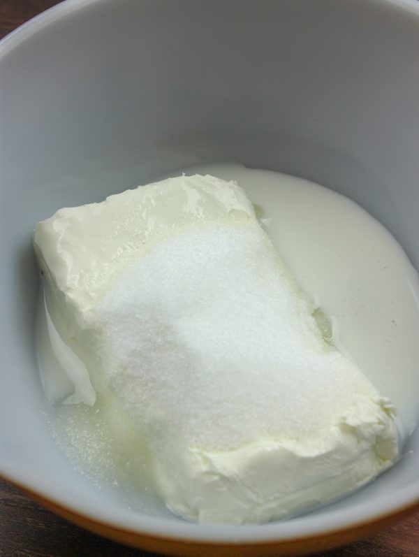 Picture of milk, sugar, and cream cheese in a bowl. 