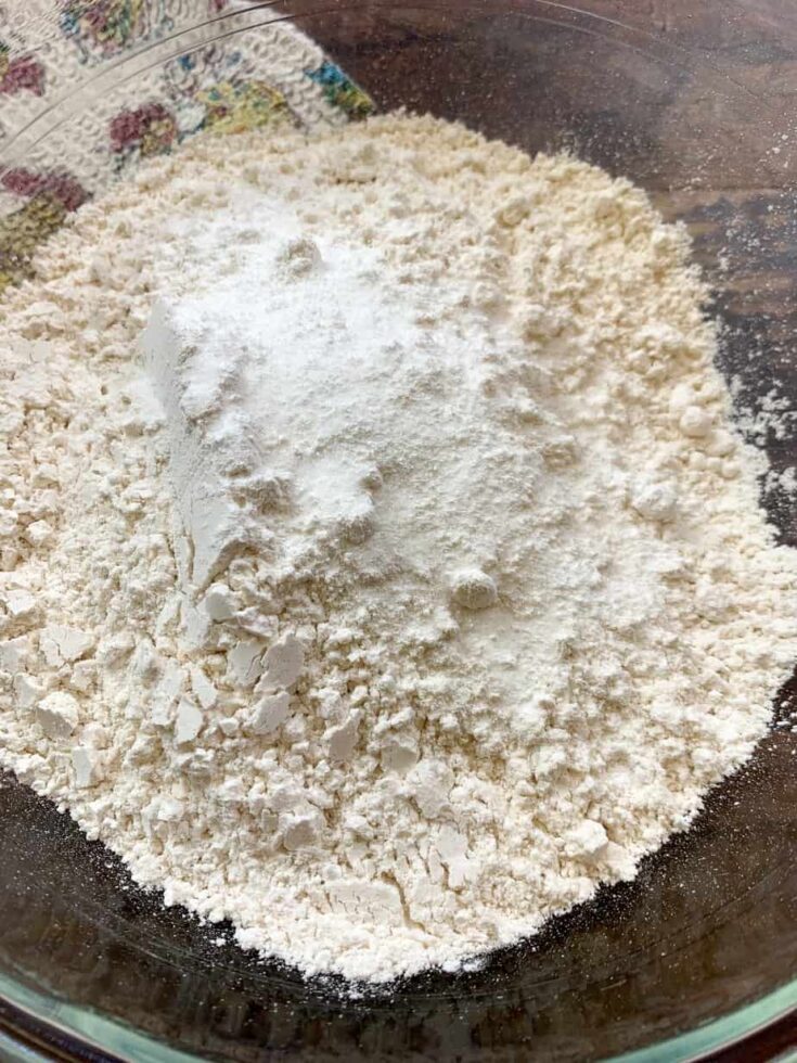 Flour, salt, and baking powder in a glass bowl. 