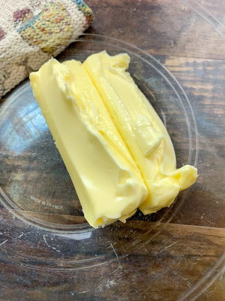 Softened yellow butter in a glass bowl