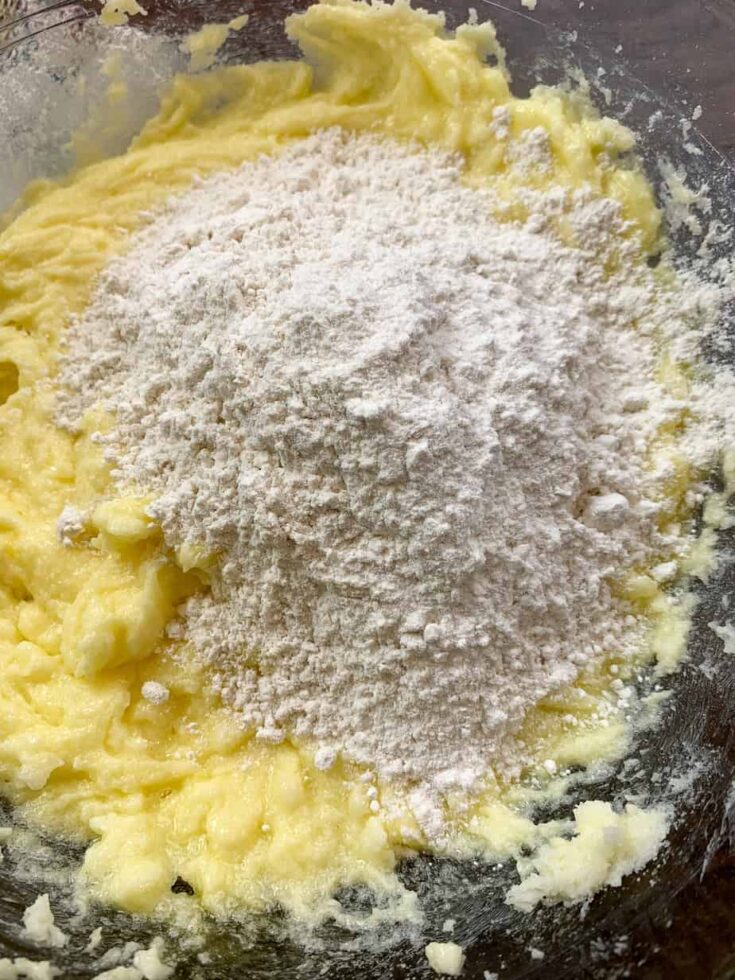 Sugar and butter mixture with flour on top in a glass bowl