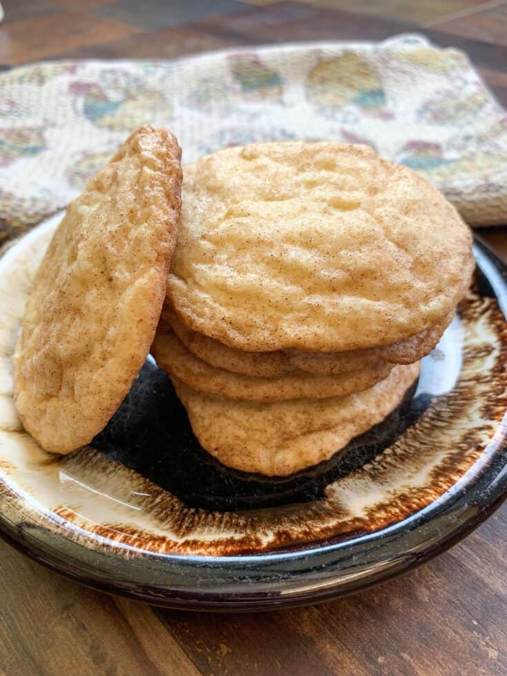 Snickerdoodle cookies stacked on a brown place