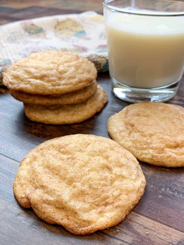 A stack of Snickerdoodle cookies next to a glass of milk