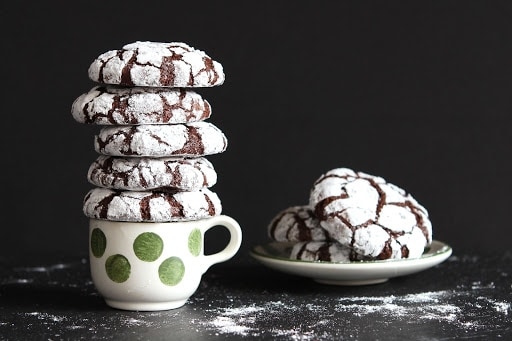 Chocolate cookies sitting on a plate and a teacup
