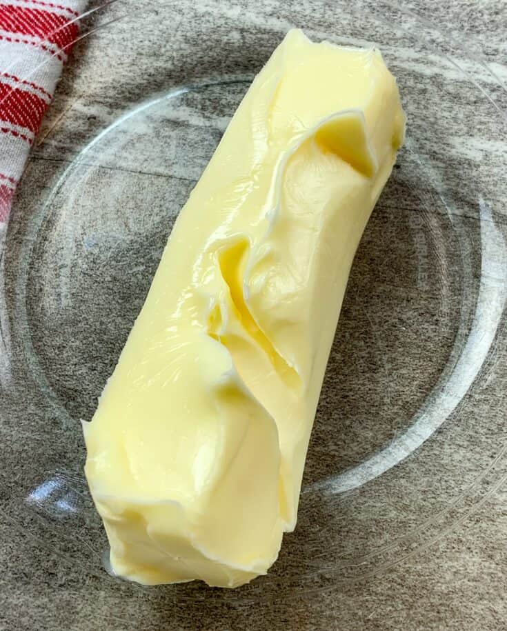 Stick of softened butter in a glass bowl