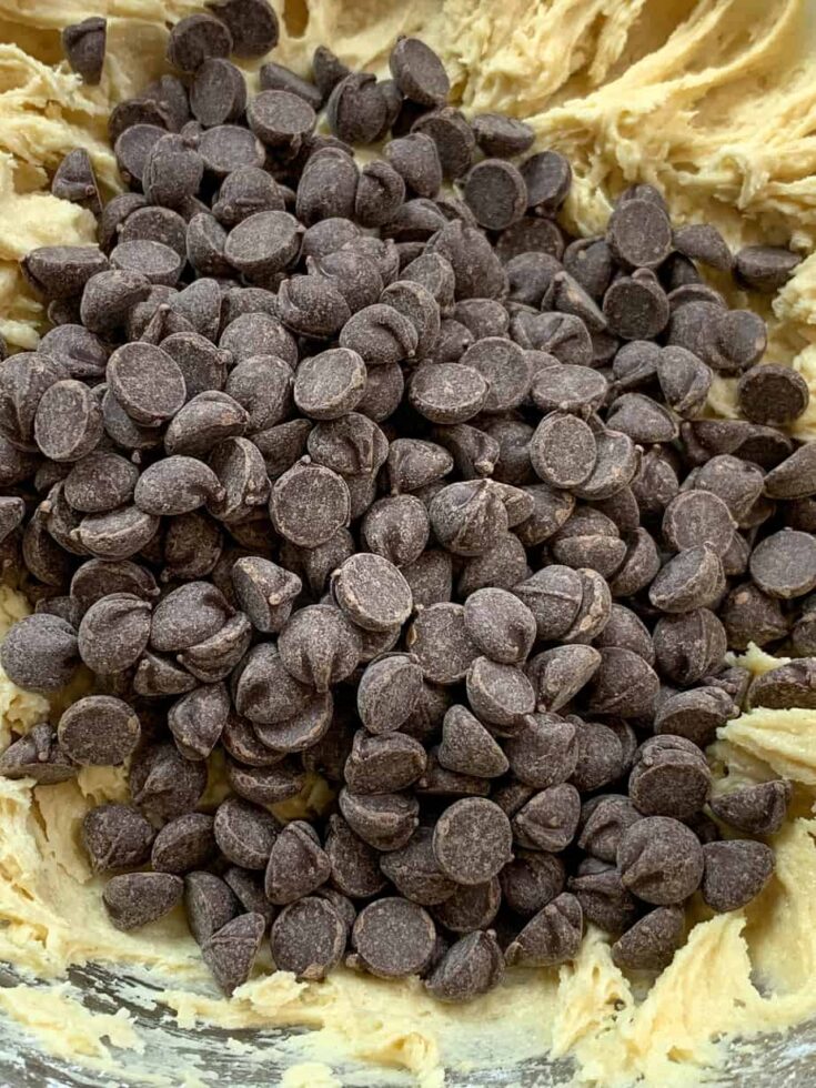 Chocolate chips in a bowl with cookie dough