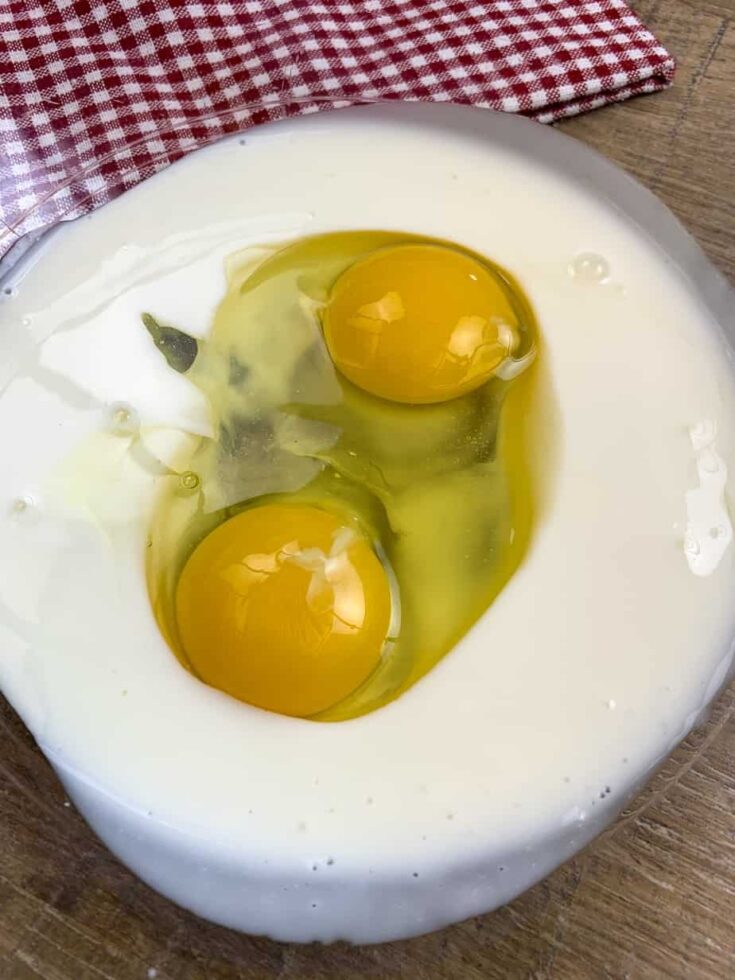 Eggs and buttermilk in a glass bowl