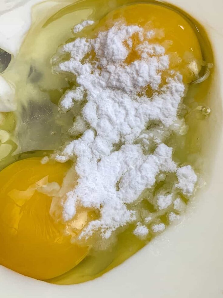 Eggs, buttermilk, and baking soda in a glass bowl