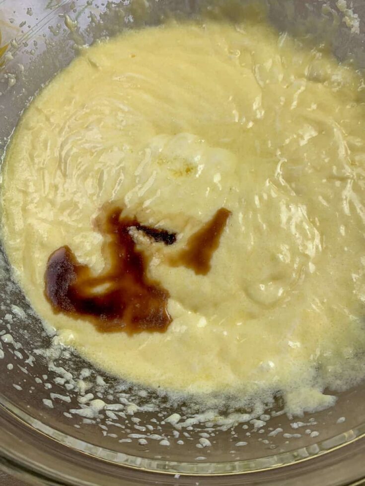 Lemon extract in a bowl with vanilla and lemon cake batter