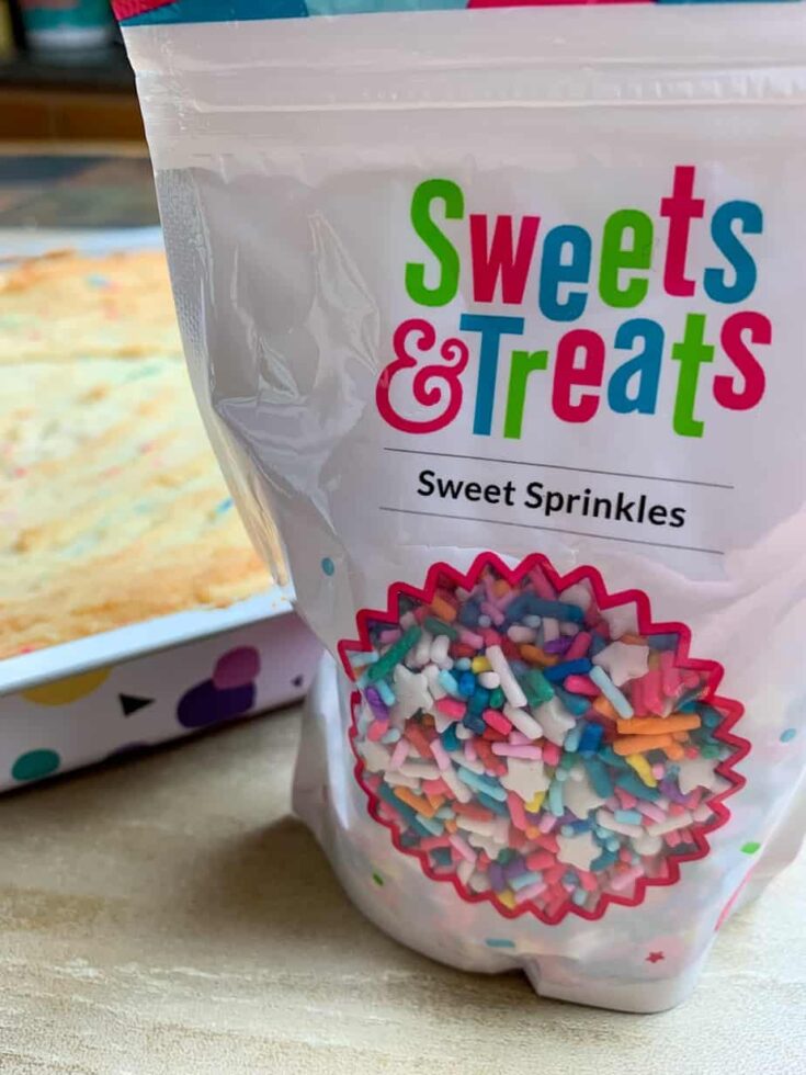 Sprinkles in a bag next to baked cookie bars