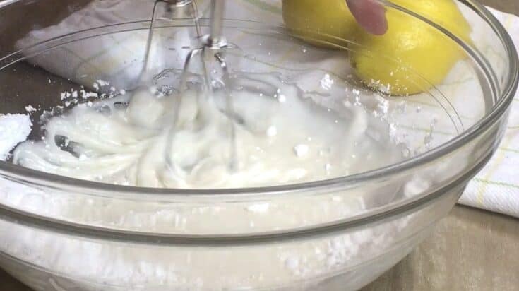 Mixing the lemon glaze with a hand mixer