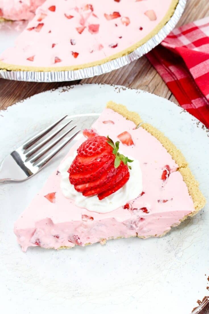 Strawberry pie on a white plate with a fork