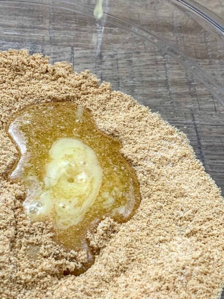 Melted butter in ground graham crackers