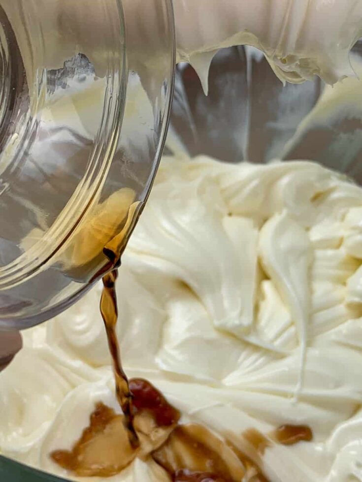 Vanilla extract and cheesecake ingredients in a large bowl