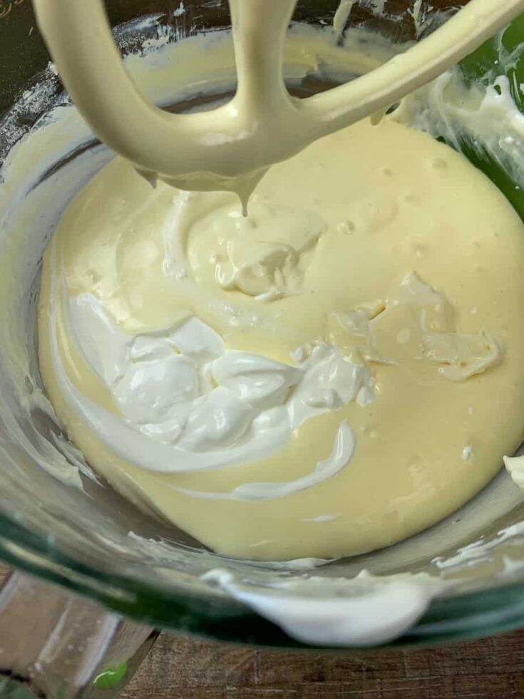 Sour cream in a bowl with cheesecake ingredients