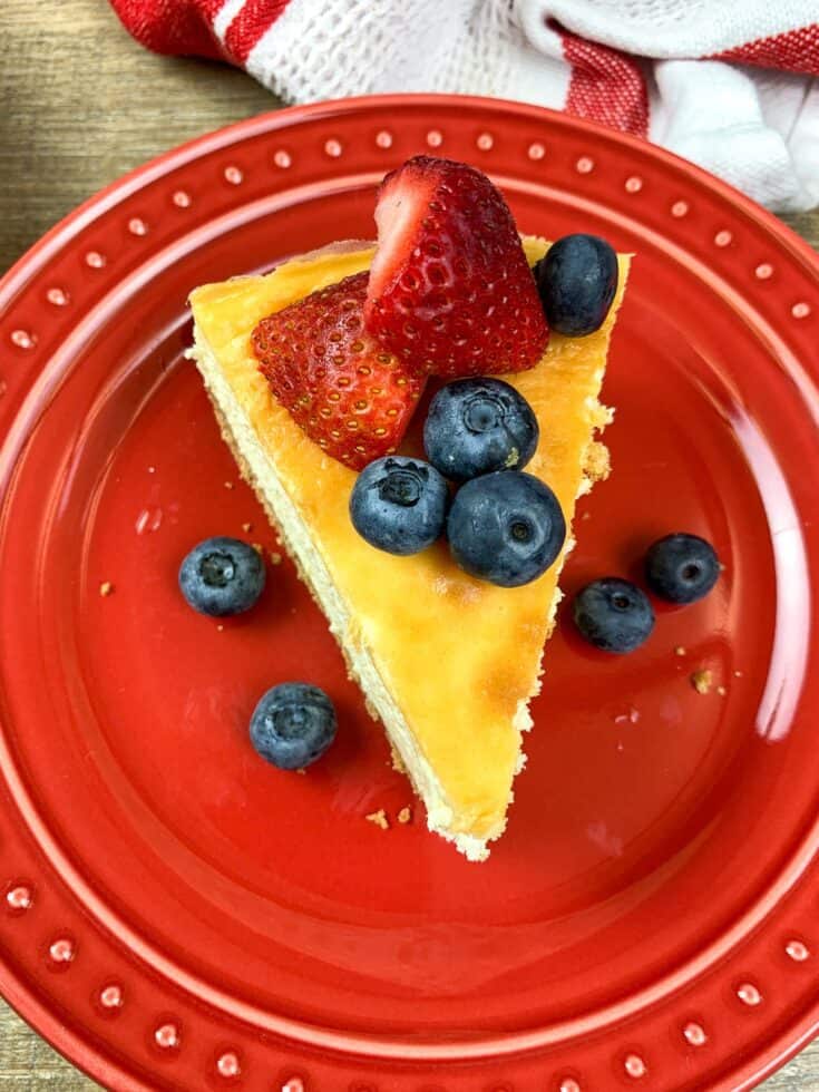 Cheesecake with fruit on a red plate