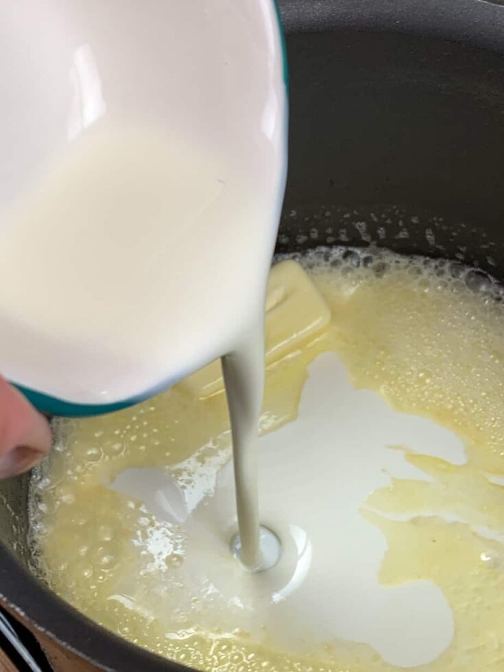 Heavy cream in a saucepan with butter.