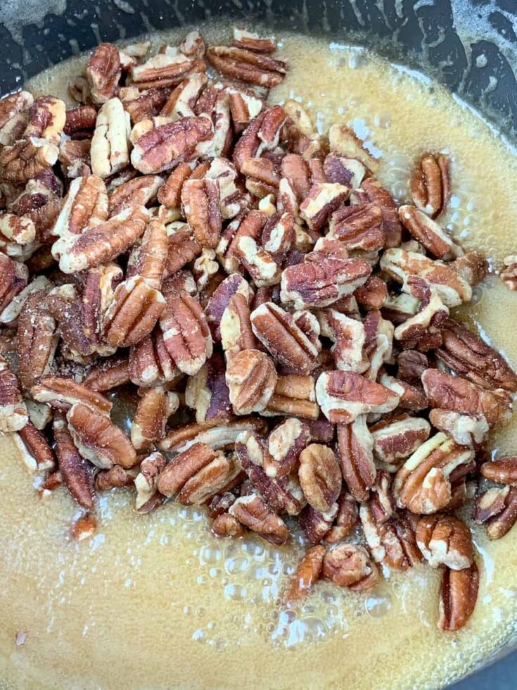 Pecans in a saucepan with butter and heavy cream