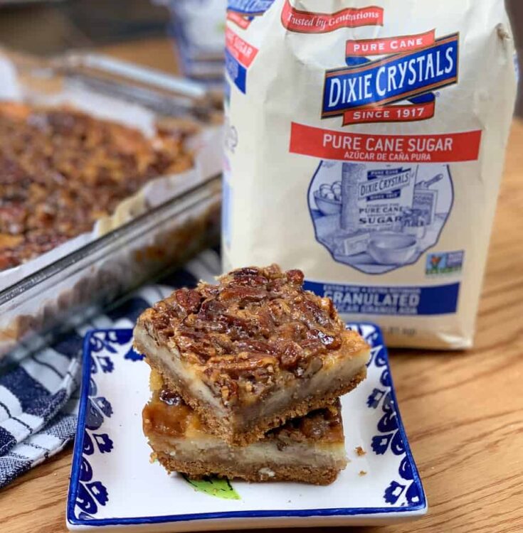 Pecan pie bars with a bag of Dixie Crystals sugar on the counter