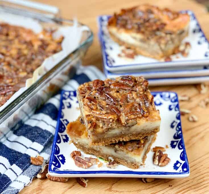 Pecan pie with cheesecake stacked on a plate