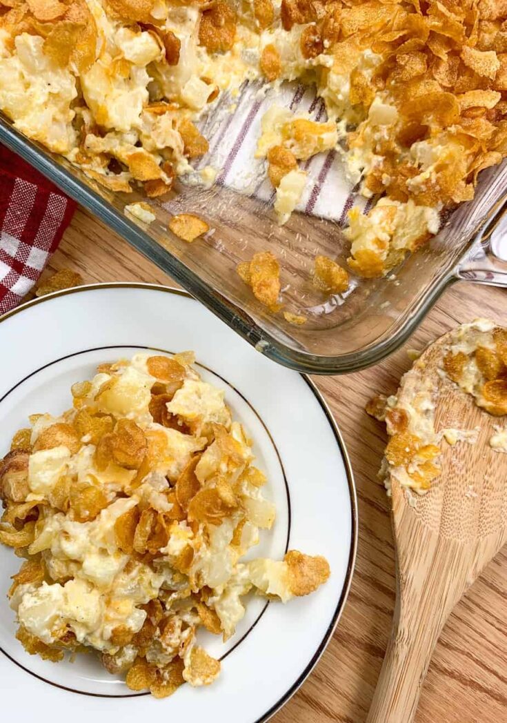 Funeral potatoes on a plate and in a casserole dish