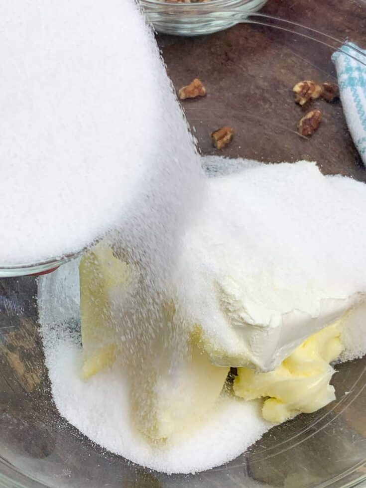 Sugar, butter, and cream cheese in a glass bowl