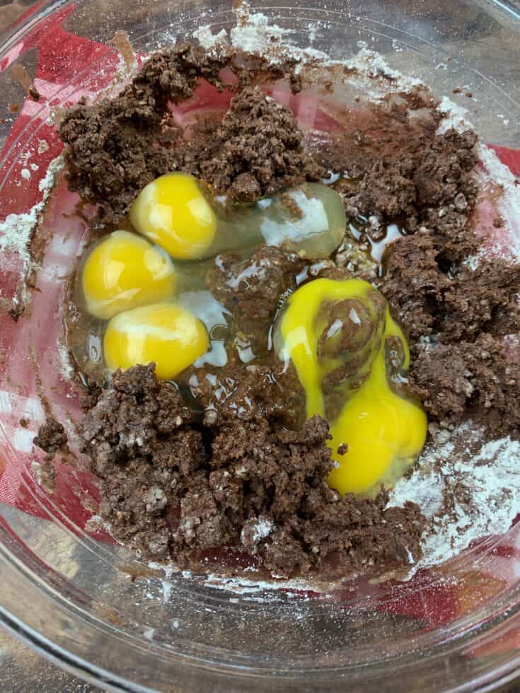 Eggs and vanilla extract in a bowl with chocolate mixture