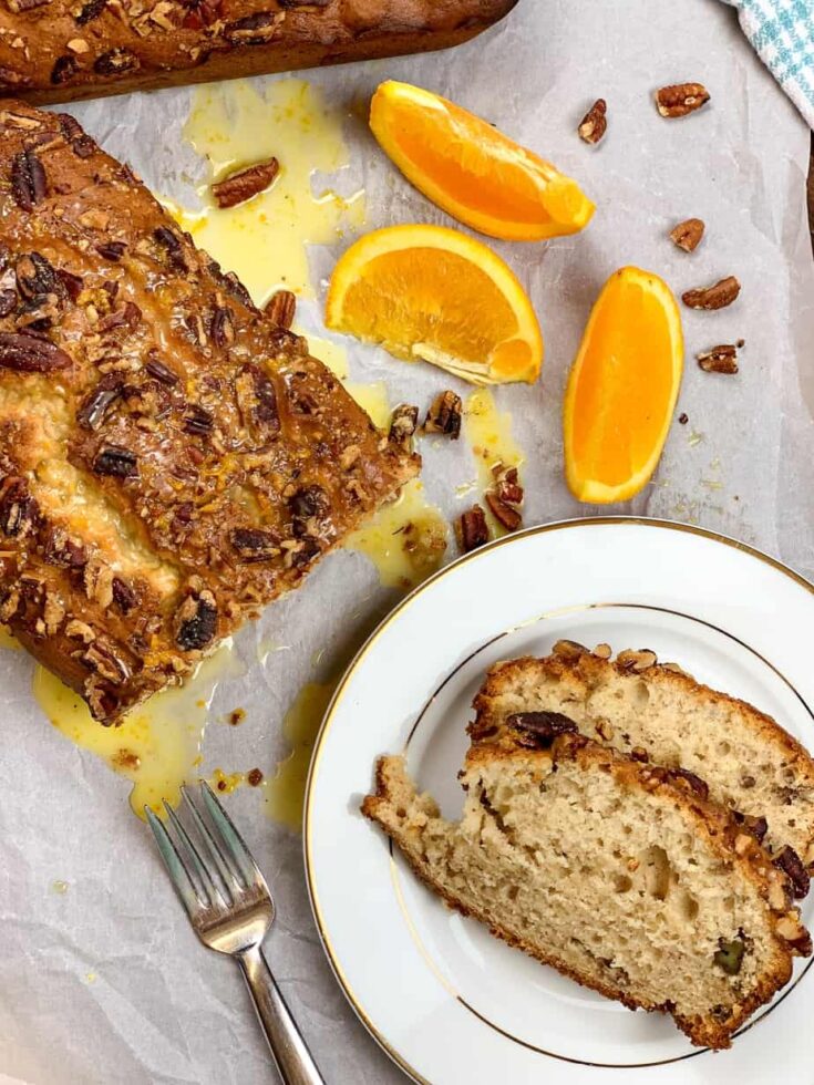 Banana bread on a plate with oranges 