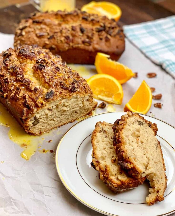 Slices of banana bread on a plate with orange slices