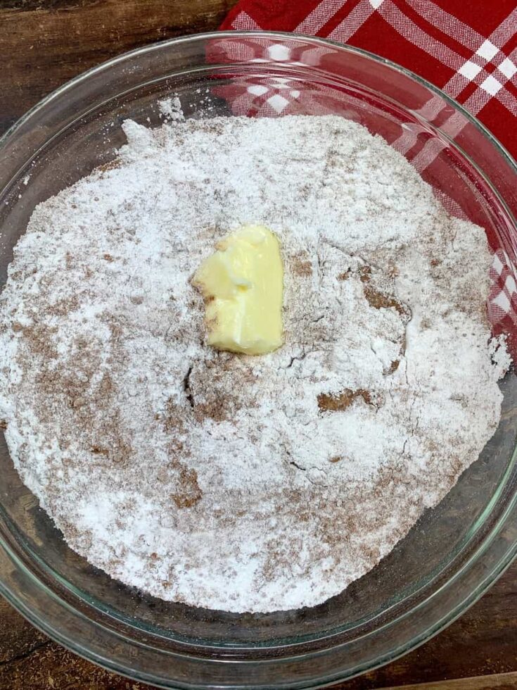 Butter in a bowl with brownie frosting mixture