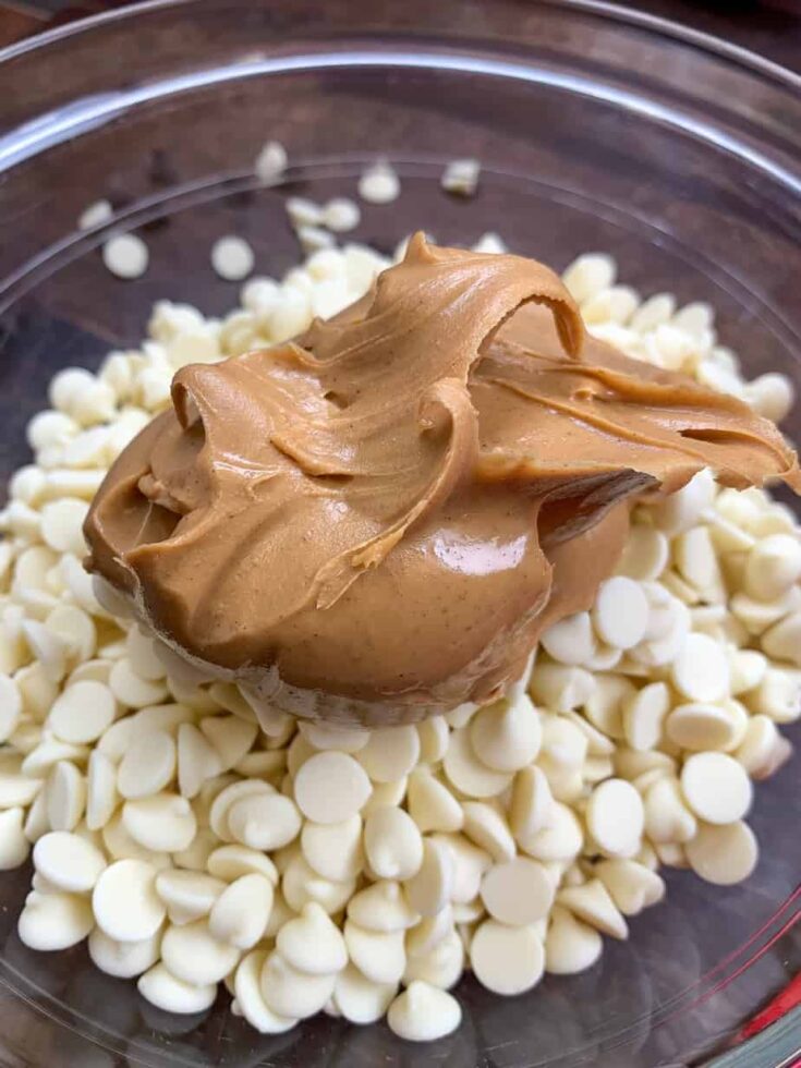 Peanut butter and white chocolate chips in a glass bowl