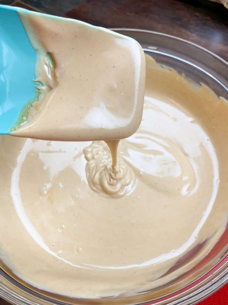 Melted peanut butter and white chocolate chips in a glass bowl