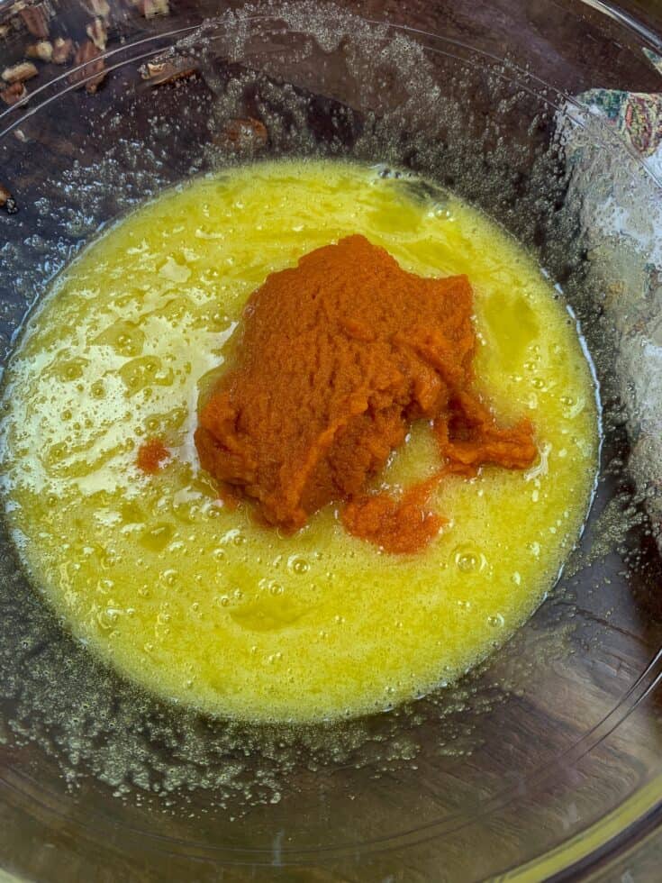 Pumpkin, eggs, and sugar in a bowl