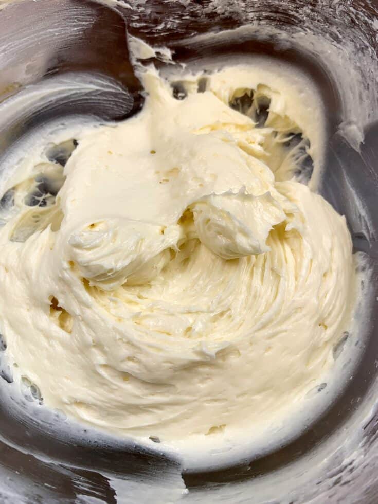 Cream cheese frosting in a glass bowl