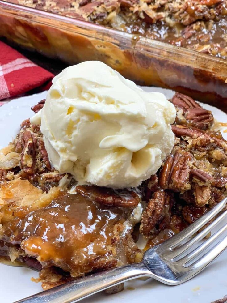 Pecan pie cobbler with ice cream on a plate