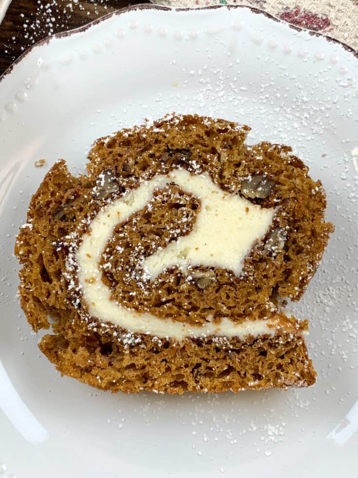 A slice of pumpkin roll cake on a plate